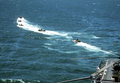 Five LVTP-7 tracked landing vehicles depart the amphibious assault ship USS SAIPAN (LHA-2)