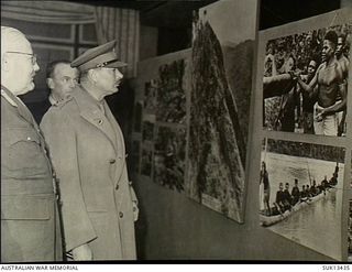 London, England. C. 1944-11-15. A photographic exhibition called "Australia at War" was shown at Simpson's Piccadilly, from 1944-11-07 to 1944-11-23. His Royal Highness the Duke of Gloucester study ..