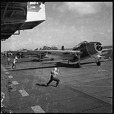 TBF's aboard USS Monterey (CVL-26) leaving flight deck for a bombing mission over Tinian Island, nearest Japanese held island to Saipan.