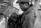 Malaysia, Republic of Fiji Military Forces soldier painting sign at camp