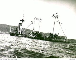 THE SOLOMON ISLANDS, 1945-10-12. A SHIP SUNK DURING WW2 STANDS UPRIGHT IN SHALLOW WATER OFF BOUGAINVILLE ISLAND. (RNZAF OFFICIAL PHOTOGRAPH.)