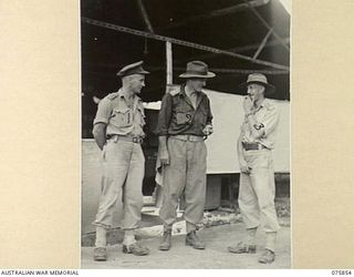 ALEXISHAFEN, NEW GUINEA. 1944-09-13. WX9920 LIEUTENANT J.W. STONE (1), VX248 MAJOR S.E. SAMUELS, COMMANDING OFFICER (2) AND QX39139 LIEUTENANT E.W. TOWNSEND (3) OUTSIDE HEADQUARTERS, 133RD BRIGADE ..