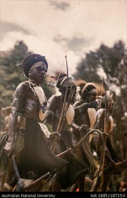 Men standing in line with bows and arrows