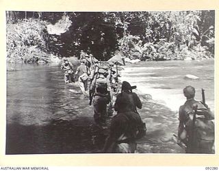 Unidentified Pioneers working with the 57/60 Infantry Battalion crossing the Hongorai River to clear the track behindadvancing infantry to allow transport through with supplies