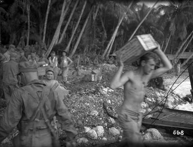 Soldiers loading rations into small landing craft, Vella Lavella Island, Solomon Islands