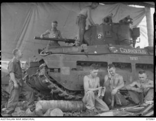 The crew of the 2/4 Matilda tank, 'Courageous', of No. 2 troop, C Squadron, 2/4th Armoured Regiment, doing their daily maintenance.  Identified personnel are: WX8574 Lieutenant L W Yorath, Officer ..