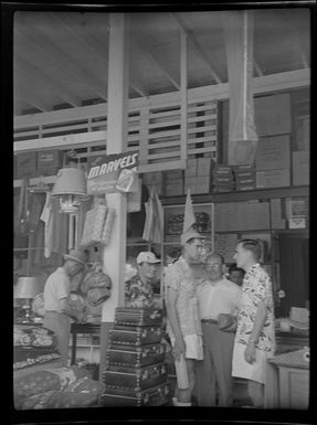 Men chatting in general store, Papeete, Tahiti