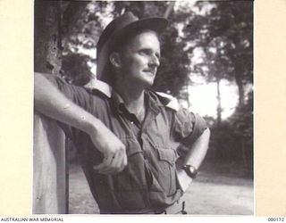 FINSCHHAFEN, NEW GUINEA. 1944-07-02. LIEUTENANT G.A. HAM, 101ST BRIGADE SUPPORT COMPANY, ADMINISTRATIVE OFFICER AT A TRANSIT CAMP SITUATED CLOSE TO LAUNCH JETTY, A TERMINAL FOR BARGE AND SMALL ..