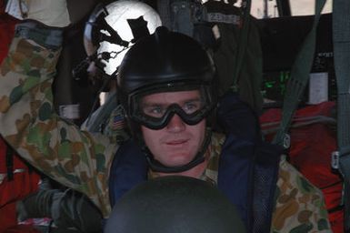 A Royal Australian Navy (RAN) Sailor waits aboard a US Navy (USN) MH-60S Sea Hawk helicopter form Helicopter Sea Combat Squadron 25 (HSC-25), during a Helicopter Rope Suspension Technique (HRST) training exercise held at Polaris Point, Santa Rita Naval Base, Guam (GU), during the Annual Multi-national Explosive Ordnance Disposal (EOD) Exercise known as TRICARB 2006." The Exercise brings together EOD Units from the US, Australia and Singapore