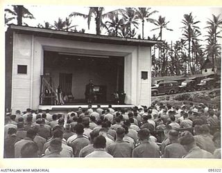 PALMALMAL PLANTATION, JACQUINOT BAY, NEW BRITAIN, 1945-08-19. THE CHAPLAIN ADDRESSING HEADQUARTERS 5 BASE SUB-AREA TROOPS DURING THE THANKSGIVING SERVICE HELD AT THE CAMEO THEATRE AT THE END OF ..