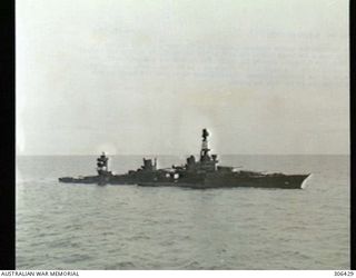 OFF RENNELL ISLAND, SOLOMON ISLANDS. 1943-01-29. DEPICTING HER DOWN BY THE STERN, LISTING STARBOARD AND LYING LOW IN THE WATER, THIS PHOTOGRAPH OF THE CRUISER USS CHICAGO WAS PROBABLY TAKEN AROUND ..