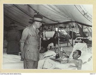 BOUGAINVILLE. 1945-03-30. LORD WAKEHURST, GOVERNOR OF NEW SOUTH WALES (1), SPEAKING TO BRIGADIER F.R. WRIGHT, U HEAVY BATTERY (2), DURING HIS VISIT TO THE 2/1 GENERAL HOSPITAL AND THE NORTH ..