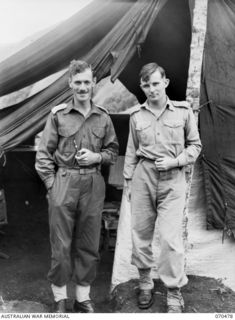 DUMPU, RAMU VALLEY, NEW GUINEA. 1944-02-09. SX1741 CAPTAIN R.J.S. SEDDON, (1), (STAFF CAPTAIN) WITH QX9500 CAPTAIN P.D. CONNOLLY, (INTELLIGENCE OFFICER), (2), MEMBERS OF THE 18TH INFANTRY BRIGADE ..