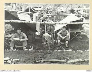 LAE, NEW GUINEA. 1944-10-27. PERSONNEL OF B COMPANY, 14/32ND INFANTRY BATTALION WITH THEIR IMPROVISED SHELTERS WHICH THEY ARE USING SINCE PACKING UP THEIR GEAR FOR EMBARKATION. IDENTIFIED PERSONNEL ..