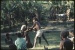 Local court case, child being pulled by men during a dispute over child's place between two groups