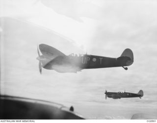 BISMARCK ARCHIPELAGO. 1944-03-28. AIRCRAFT, CODE NAMED UP-T, UP-S, OF NO. 79 (SPITFIRE) SQUADRON RAAF, IN FLIGHT OVER NEW BRITAIN EN ROUTE FROM KIRIWINA TO THE ADMIRALTY ISLANDS. PHOTOGRAPH TAKEN ..