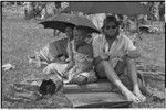 Mortuary ceremony: Edwin Hutchins and women side in shade under umbrellas