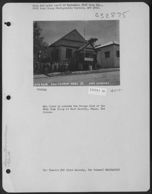 Men Lined Up Outside The Troops Club Of The 38Th Bomb Group At Port Moresby, Papua, New Guinea. (U.S. Air Force Number 121911AC)