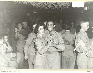LAE, NEW GUINEA. 1944-09-25. SERGEANT T. RICHARDSON (2), AND SERGEANT A.R. RUTTLEY (3), DANCING WITH GUESTS DURING THE OFFICIAL OPENING OF NO. 1 SERGEANTS' MESS, HEADQUARTERS NEW GUINEA FORCE