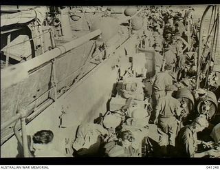 At Sea, off Papua. 1942-12-14. Members of the AIF disembarking from HMAS Broome to go into action at Buna