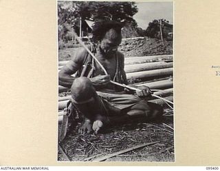 KIARIVU, NEW GUINEA, 1945-08-12. AUSTRALIAN NEW GUINEA ADMINISTRATIVE UNIT NATIVES ARE BUILDING HUTS FOR THE AUSTRALIAN NEW GUINEA ADMINISTRATIVE UNIT HEADQUARTERS IN THE 2/7 INFANTRY BATTALION ..