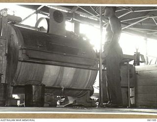 17 MILE, PORT MORSEBY AREA, NEW GUINEA. 1943-12-04. A WASHING MACHINE IN THE BUILDING WHICH HOUSES THE 9TH AUSTRALIAN DIVISION MOBILE LAUNDRY