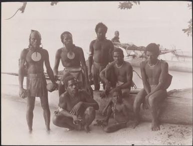 Six men and a boy on a beach at Vanikolo, Santa Cruz Islands, 1906 / J.W. Beattie