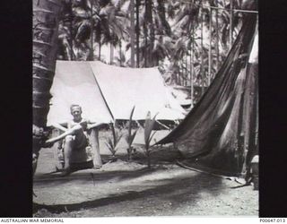 MILNE BAY, PAPUA, C.1942 - 43. SERGEANT W. LOFBERG OUTSIDE THE WIRELESS TELEGRAPHY TENT AT NO. 37 RAAF RADAR STATION. (DONOR - T.G. JONES)