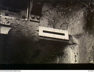 Fortification Point, New Guinea. 1944-04-08. An interior view inside a disabled Australian Matilda tank showing the effect of a trial round fired from a Japanese 75mm field gun, pack type, Meiji ..