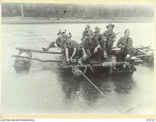 BORAI RIVER, NEW GUINEA. 1944-08-02. TROOPS OF THE 30TH INFANTRY BATTALION ON PATROL IN THE AREA, CROSSING THE SWIFTLY FLOWING RIVER BY MEANS OF A RAFT MADE OF EMPTY JAPANESE OIL DRUMS. IDENTIFIED ..