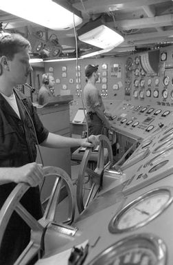 Sailors monitor instrument consoles in an engineering space aboard the amphibious assault ship USS SAIPAN (LHA-2) as preparations are made to shut down one of the ship's boilers for maintenance. The SAIPAN steamed at flank speed for a week to be on station off the coast of Liberia for OPERATION SHARP EDGE