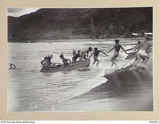 BUT-DAGUA AREA, NEW GUINEA. 1945-04-12. SENATOR J.M. FRASER, ACTING MINISTER FOR THE ARMY (1), AND LIEUTENANT GENERAL J. NORTHCOTT, CHIEF OF THE GENERAL STAFF (2), BEING PULLED ASHORE BY ..