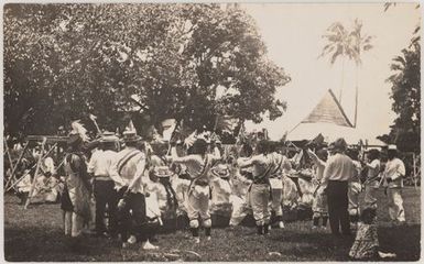 Cook Islanders performing holding union jack flags