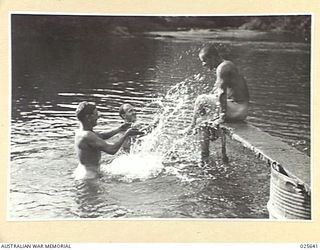 PORT MORESBY, PAPUA. 1942-07. RELAXING AFTER A LONG ROUTE MARCH, AUSTRALIAN TROOPS ENJOY THE FRESHNESS OF A NEW GUINEA MOUNTAIN STREAM