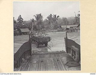 CAPE WOM, WEWAK AREA, NEW GUINEA. 1945-09-06. A TRUCK OF 6 DIVISION POSTAL UNIT, MOVING OFF BARGE AFTER BEING LOADED WITH MAIL