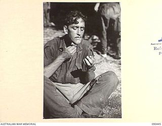 WONGINARA MISSION, NEW GUINEA. 1945-04-04. CORPORAL A.C. ANDERSON, 2/3 INFANTRY BATTALION, SHAVING AFTER HIS RETURN FROM FORWARD POSITIONS IN THE TORRICELLI MOUNTAINS, INLAND FROM DAGUA