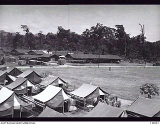 LAE, NEW GUINEA. 1945-12. THE AREA CONSISTING OF MENS LINES, PARADE GROUND, POWER HOUSE NO. 3 SUB-DEPOT STOREHOUSES, AT 4 ADVANCED ORDNANCE DEPOT