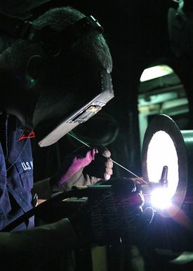 U.S. Navy Hull Technician 1ST Class Billy D. King uses a gas tungsten arc welder to patch together piping aboard the Tarawa Class Amphibious Assault Ship USS SAIPAN (LHA 2) during operations in the Gulf of Aden on Sept. 7, 2006. SAIPAN is currently underway conducting maritime security operations in the Persian Gulf. (U.S. Navy photo by Mass Communication SPECIALIST Third Class Erik Siegel) (Released)