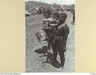 1943-03-15. NEW GUINEA. BUGLERS FROM THE ADMIRALTY ISLANDS SOUNDING THE GENERAL SALUTE WHEN THE ADMINISTRATOR OF THE ISLAND INSPECTED THE ROYAL PAPUAN CONSTABULARY AT A CEREMONIAL PARADE SOMEWHERE ..