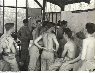 MOMOTE, LOS NEGROS ISLAND, ADMIRALTY ISLANDS. 1944-03-08. BARE-CHESTED RAAF KITTYHAWK PILOTS BEING BRIEFED IN THEIR CREW ROOM ON MOMOTE AIRSTRIP BEFORE AN OPERATION OVER THE ADMIRALTY ISLANDS