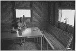 Edwin Cook's house in Kwiop: Nancy Cook at a table