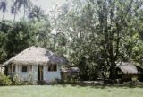 French Polynesia, thatched-roofed cottage on Tahiti Island