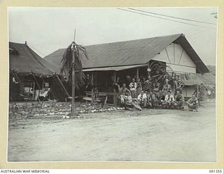 TOROKINA, BOUGAINVILLE. 1945-04-27. A GENERAL VIEW OF WARD NO. 13, THE LATEST TO BE OPENED AT 2/1 GENERAL HOSPITAL, SHOWING A GROUP OF PATIENTS AND SISTER K. MILLER, AUSTRALIAN ARMY NURSING SERVICE ..