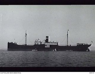 PORT MORESBY, PAPUA. 1941-10-27. PORT SIDE VIEW OF THE AMERICAN CARGO VESSEL VINCENT. NOTE THE PROMINENT FLAG PAINTED ON THE SHIP'S SIDE PROCLAIMING HER NEUTRALITY. (NAVAL HISTORICAL COLLECTION)