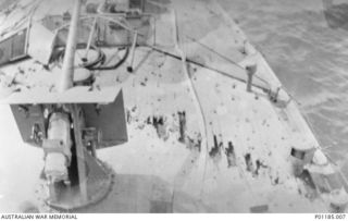 ORO BAY, PNG, 1943-04-11. THE FOREDECK OF HMAS PIRIE SHOWING DAMAGE CAUSED BY CANNON FIRE INCLUDING HOLES IN THE DECK TIMBERS. (DONOR J. LYALL)