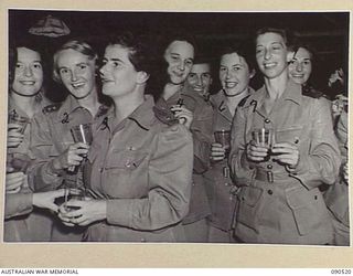 LAE, NEW GUINEA. 1945-03-26. AUSTRALIAN ARMY NURSING SERVICE PERSONNEL AT THE SISTERS MESS, 2/7 GENERAL HOSPITAL, DURING THE VISIT OF LADY WAKEHURST AND LADY BLAMEY. IDENTIFIED PERSONNEL ARE:- ..