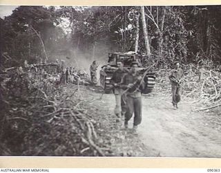 BOUGAINVILLE. 1945-04-05. A B SQUADRON, 2/4 ARMOURED REGIMENT MATILDA TANK SUPPORTED BY 25 INFANTRY BATTALION TROOPS MOVING BACK TO B ECHELON FROM SLATER'S KNOLL AFTER THE ATTACK AGAINST THE ..