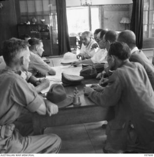 MACASSAR, 1945-09-22. OCCUPATION OF MACASSAR BY THE 2-27TH BATTALION. BRIG I.N DOUGHERTY, CO OF THE AUST OCCUPATION FORCES, CHECKING MAPS WITH VICE ADMIRAL OHSUGI, IMPERIAL JAPANESE NAVY