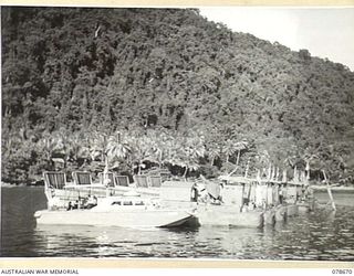 BAIEN AREA, NEW BRITAIN. 1945-01-26. AN AMERICAN "J" BOAT AND LCM'S (LANDING CRAFT MECHANISED) OF THE 594TH ENGINEER BOAT AND SHORE REGIMENT, "B" COMPANY, UNITED STATES ARMY MOORED TO A SUNKEN ..