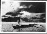Hawaiian fisherman spearing fish from a boat